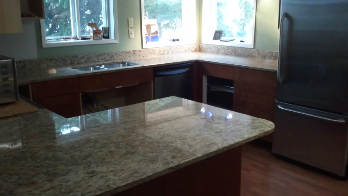 Polished natural-stone countertops in a bright kitchen