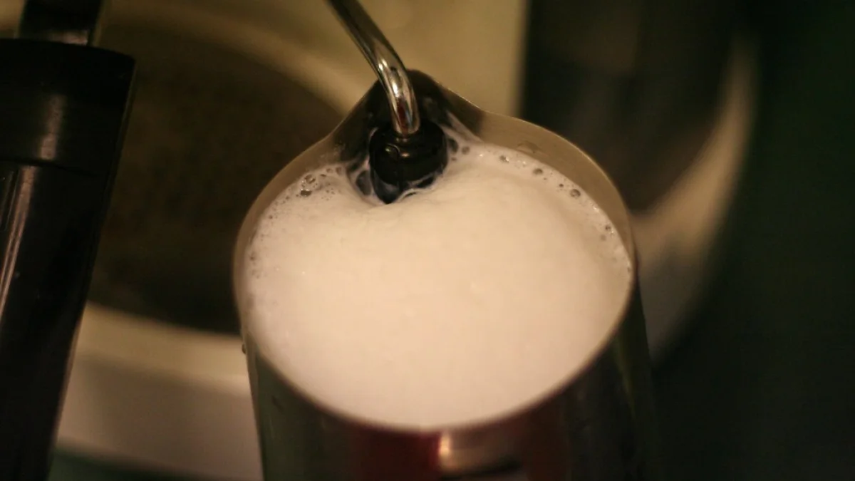 Cold milk being aerated with a handheld frother