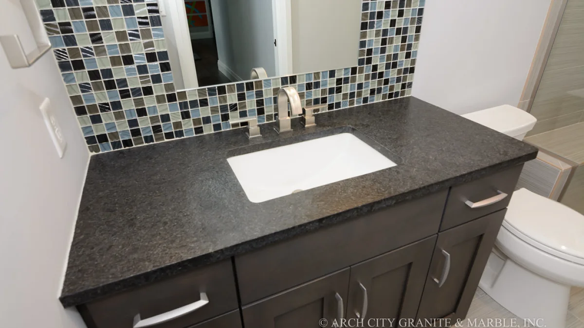 Dark soapstone countertop in a finished kitchen